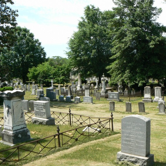 Headstones near the east wall of the cemetery